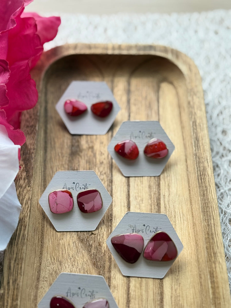 A pair of faux stone square stud earrings in pink and red