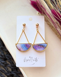 Gold-tone dangle earrings with semicircle marble stone pendants in purple, blue, and pink,