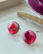 A pair of pebble shaped stud earrings with oval pink and red faux stone finish