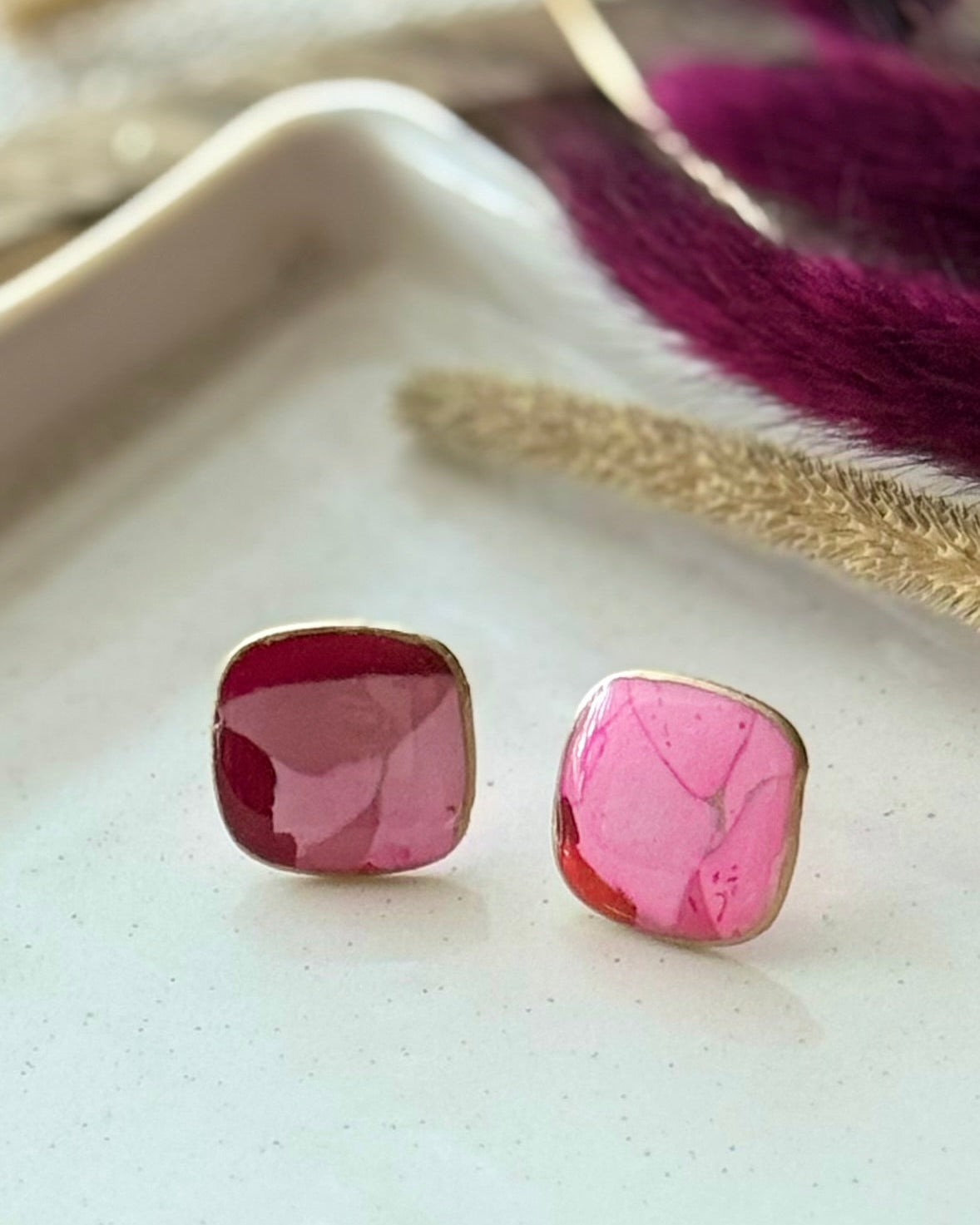A pair of faux stone square stud earrings in pink and red
