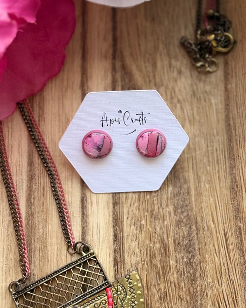 A pair of round pink marbled stud earrings