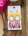 Multicolor dangle earrings with large brass medallion and three faux stone dangles in pink and black