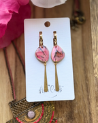 Pink marbled drop earrings with gold-toned dangling bars,