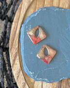 Diamond shaped charm with a teardrop keyhole in amber stained glass design