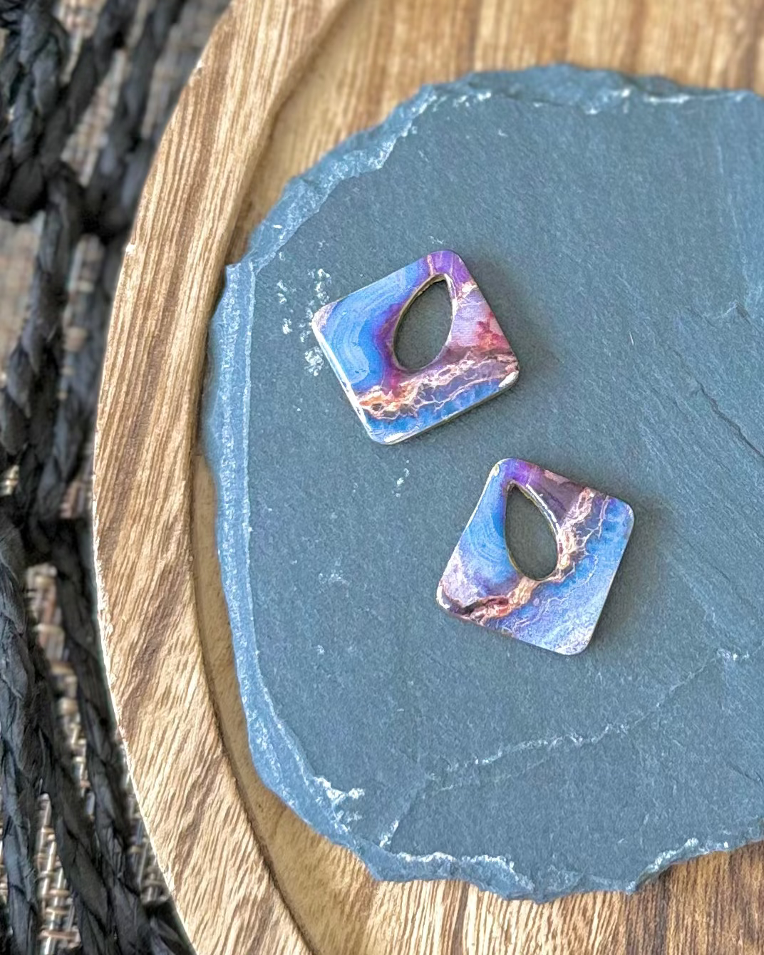 Diamond shaped charm with a teardrop keyhole in a purple and blue marble