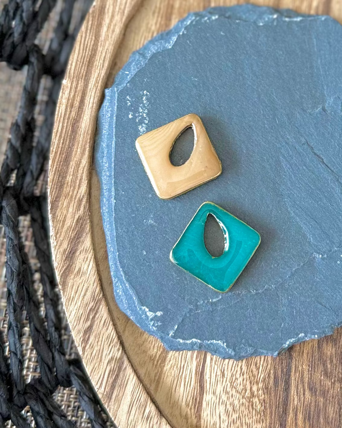Diamond shaped charm with a teardrop keyhole in reversible amber and jade